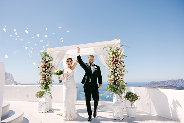 Romantic Santorini elopement with incredibly beautiful white flowers │ Basak & Zack